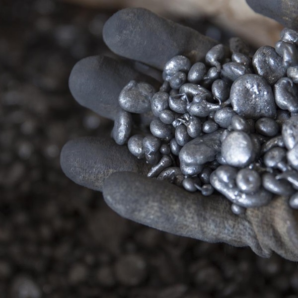 a glove hand holding nickel