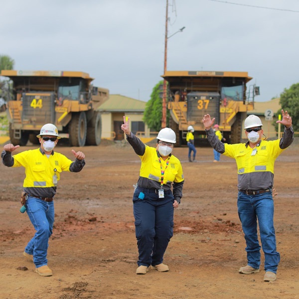 Workers at our Cerro Matoso operation posing for the camera in front of some trucks