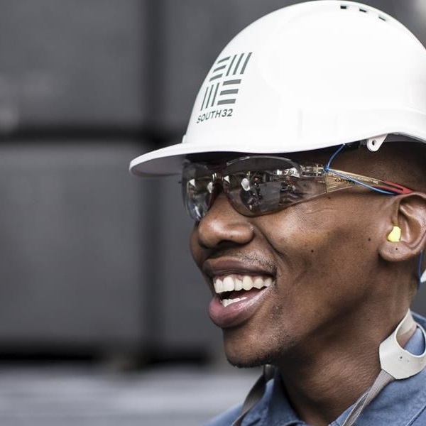 A photo of workers at hillside wearing safety glasses and hard hats