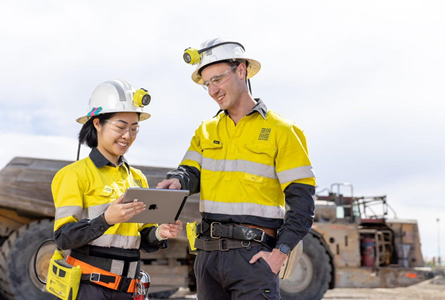 two workers looking at ipad