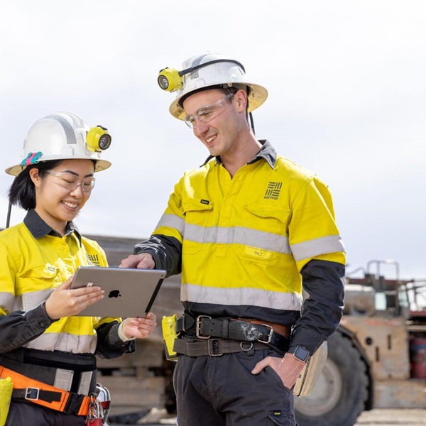 two workers looking at ipad